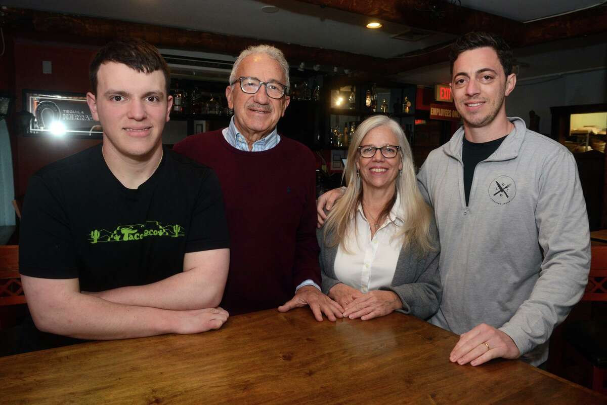 Long time owners Miguel and Rosemarie Tomasio and their sons Carlo, left, and Zachary at Taco Loco, in Bridgeport, Conn. April 26, 2022.