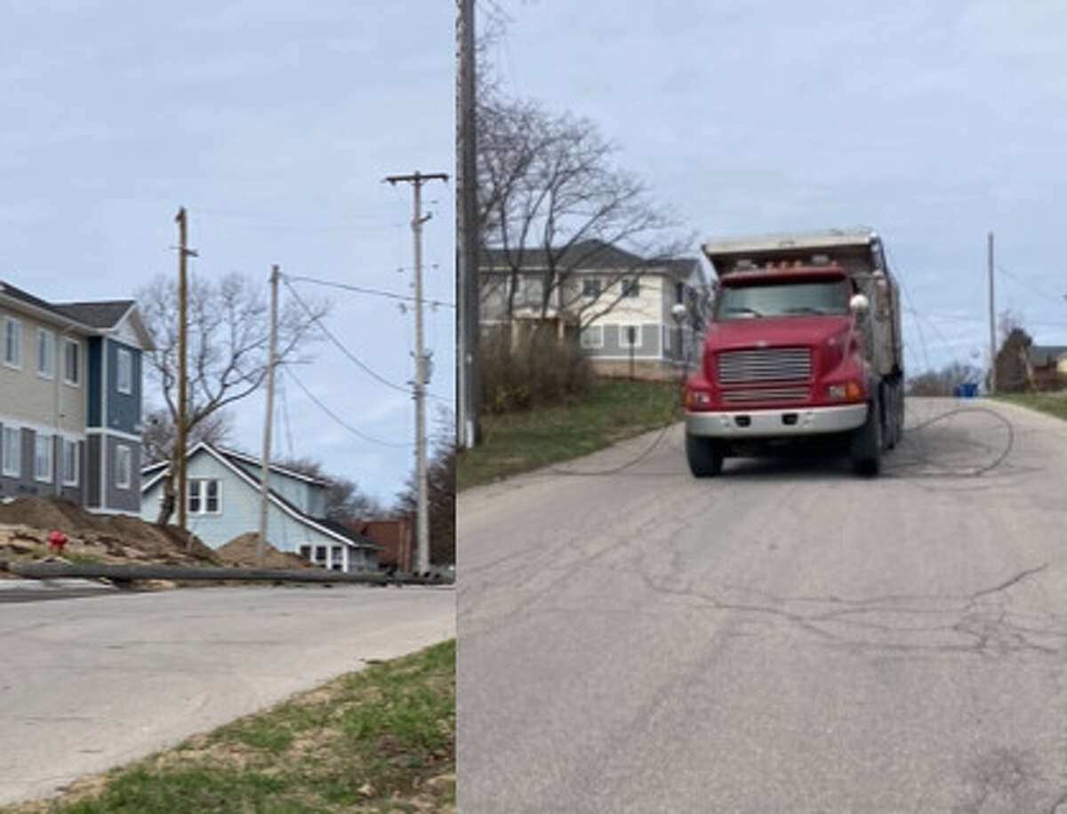 A driver of a dump truck was stuck in the vehicle on Monday after the vehicle became entangled in hanging power lines in Manistee.