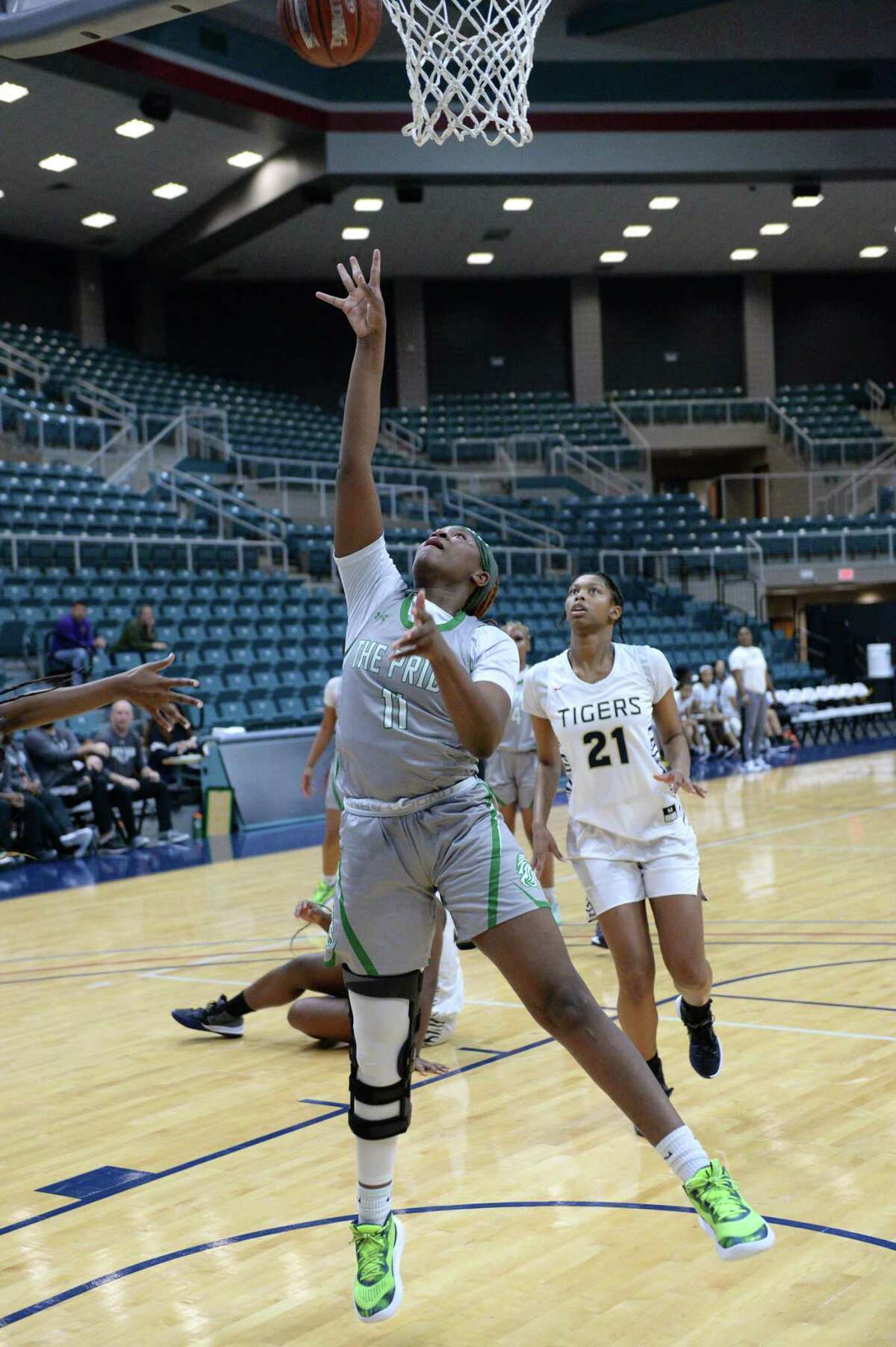 Rikeyah Gant (11) of Spring attempts a layup during the second half of a game between the Spring Lions and the Klein Collins Tigers in the Katy ISD Basketball Classic on Friday, December 3, 2021 at the Leonard Merrill Center, Katy, TX.