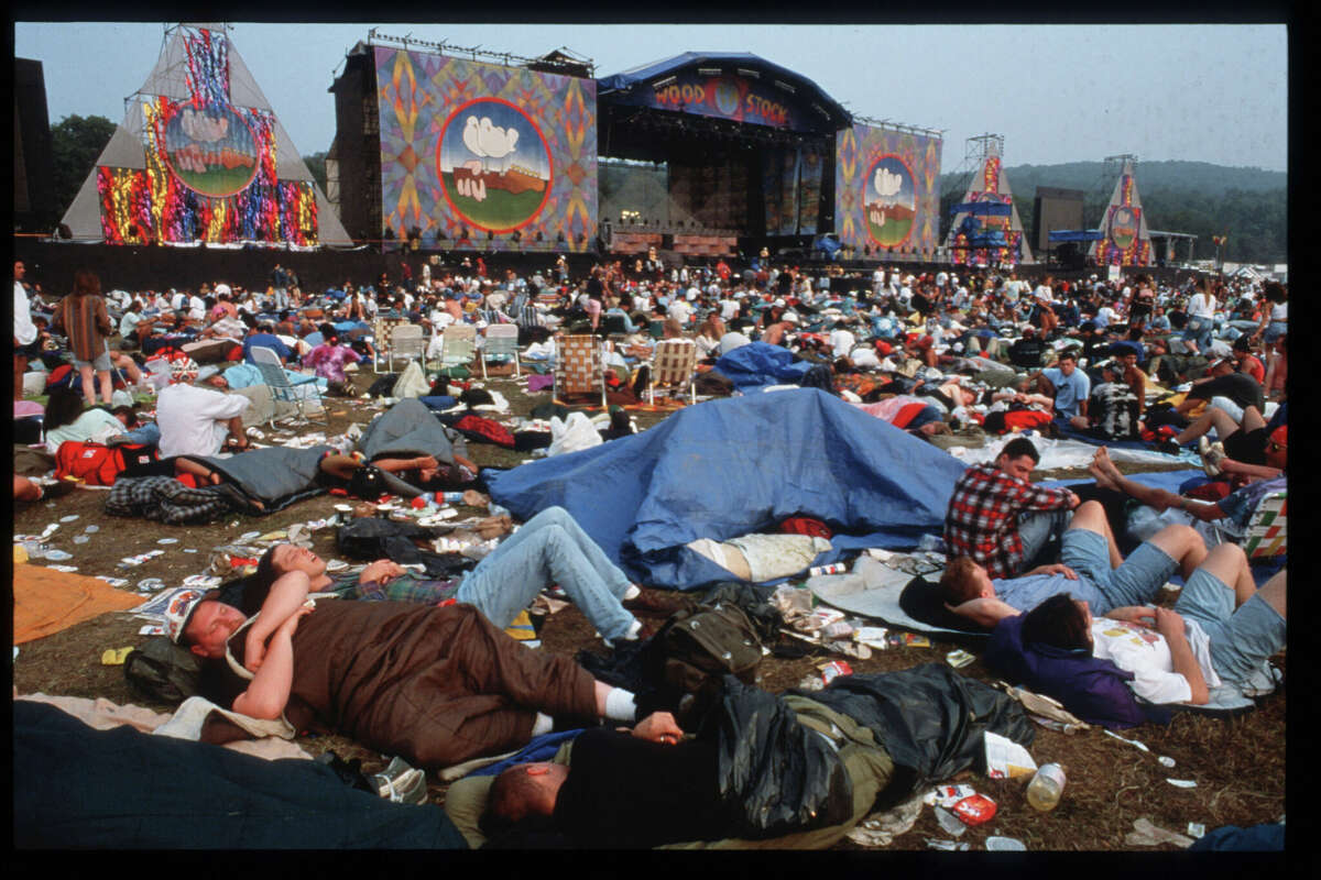 Spectators sleep at the Woodstock 25th anniversary concert August 13, 1994 at Winston Farm in Saugerties, an event that attracted 350,000 spectators. Three local businessmen are proposing a major development on the historic 800-acre farm.