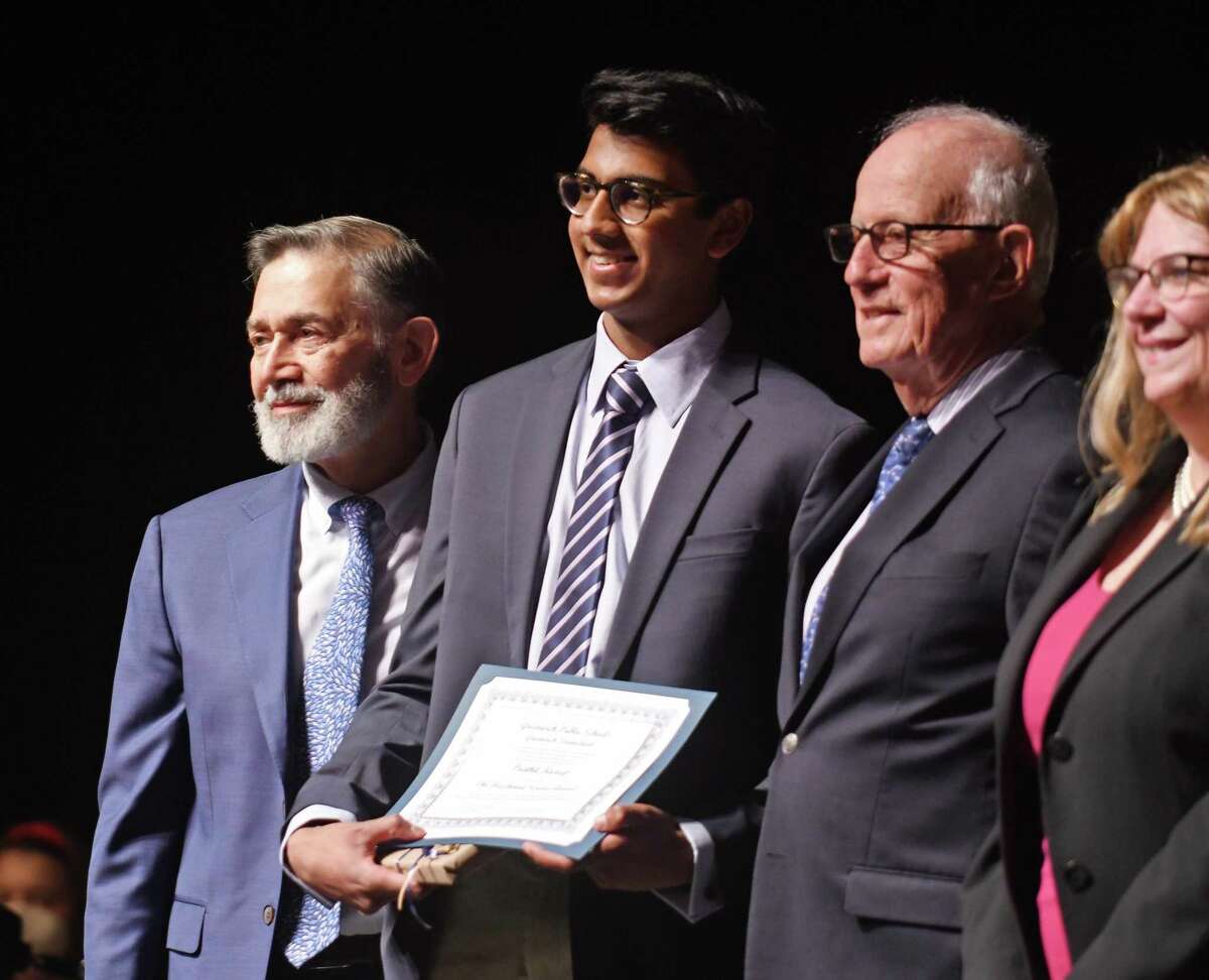 GHS senior Prathit Kurup, center, is presented with the Fleishman Service Award from GHS Principal Ralph Mayo, left, and former Superintendent of Schools Ernest Fleishman at the Greenwich Public Schools Community Service Awards Ceremony.