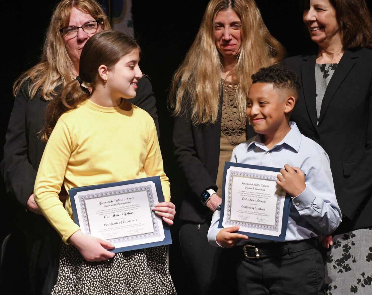Julian Curtiss School students Ava Moien Afshari, left, and Lester Perez Rosario are awarded Certificates of Excellence by Superintendent of Schools Toni Jones, Board of Education Chair Kathleen Stowe, and Julian Curtiss Principal Patricia McGuire at the Greenwich Public Schools Community Service Awards Ceremony.