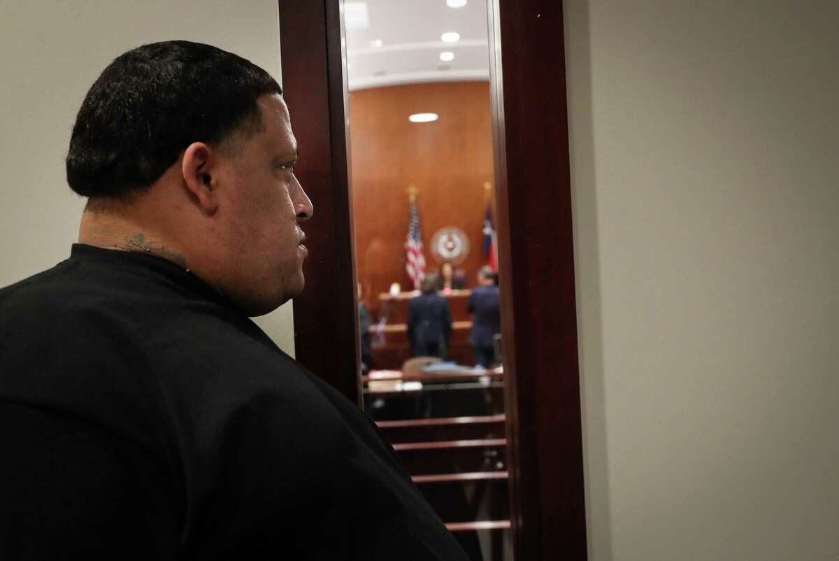 Christopher Cevilla, father of Jazmine Barnes, looks towards Larry Woodruffe through a public viewing window as Woodruffe’s capital murder trial begins Tuesday, April 26, 2022, at the Harris County Criminal Courthouse in Houston. Woodruffe is accused of capital murder for the 2018 shooting death of Cevilla’s daughter Jazmine Barnes. Seven-year-old Barnes was shot in the head during a drive-by shooting while she sat in a car with family members.