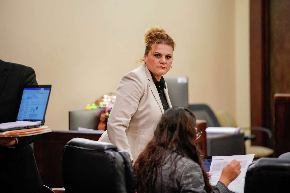Angelica Navarro-DePaz looks around the courtroom as testimony began Tuesday morning in her murder-for-hire trial in the 437th District Court.