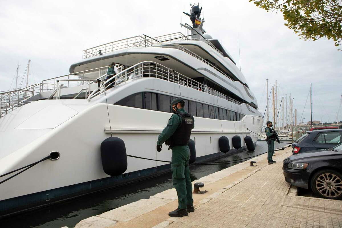 Civil Guards stand by the yacht called Tango in Palma de Mallorca, Spain, Monday April 4, 2022. U.S. federal agents and Spain's Civil Guard are searching the yacht owned by a Russian oligarch. Such yachts — and their powerful owners — are prominent motifs in first-time novelist Jay Newman’s political thriller ‘Undermoney.’ (AP Photo/Francisco Ubilla, File)