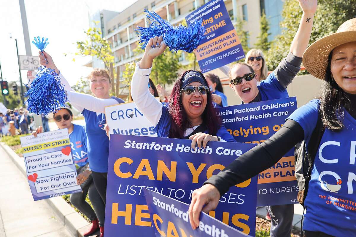 Nurse Maria Villaflordino (center) and others cheer at a rally outside of Lucile Packard Children's Hospital on Monday, April 25, 2022 in Palo Alto, California.
