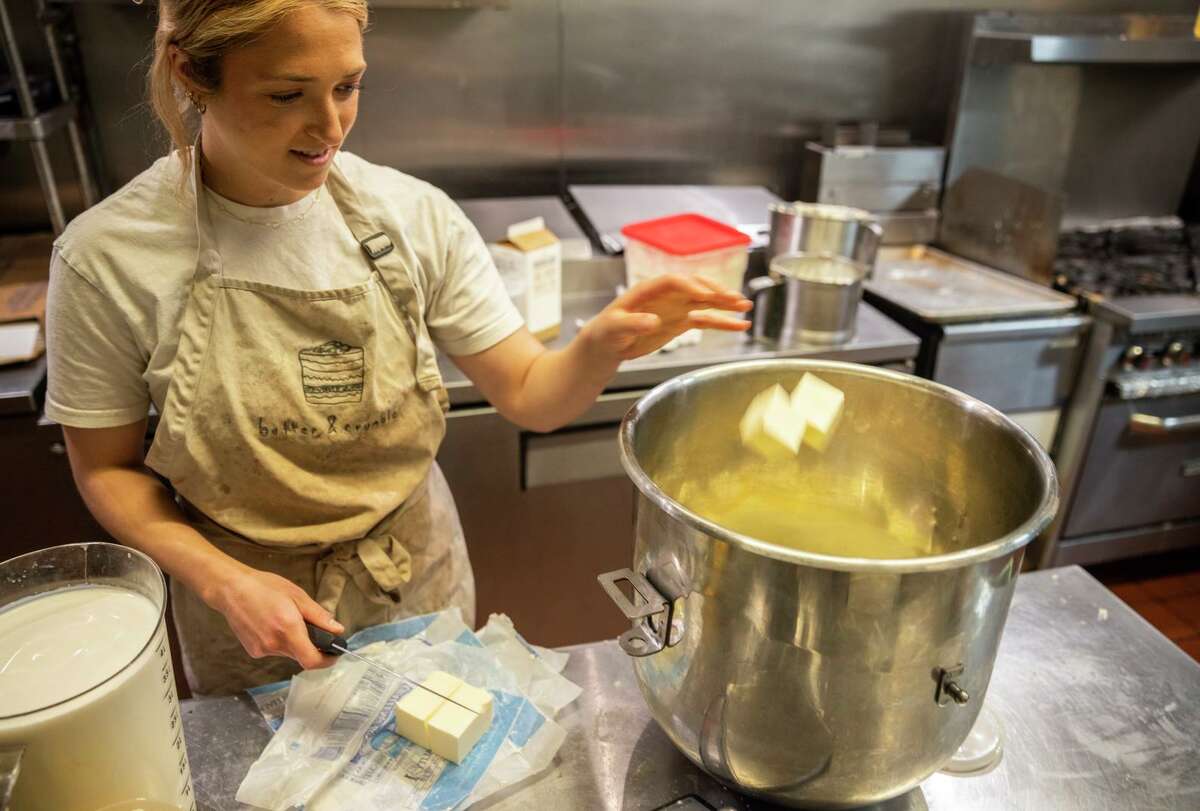 Sophie Smith, owner and baker of Butter & Crumble, tosses cubes of butter into a mixing bowl while making buttercream in the Marina neighborhood of San Francisco, Calif. Wednesday, April 13, 2022. 