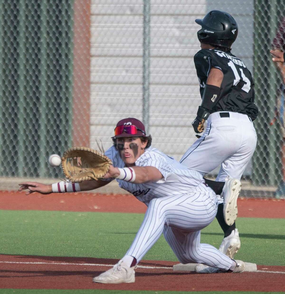 Legacy High's Chase Shores stretches for the ball on first but Abilene High's Jamison Castel beats the throw for a hit 04/26/2020 at Ernie Johnson Field. Tim Fischer/Reporter-Telegram