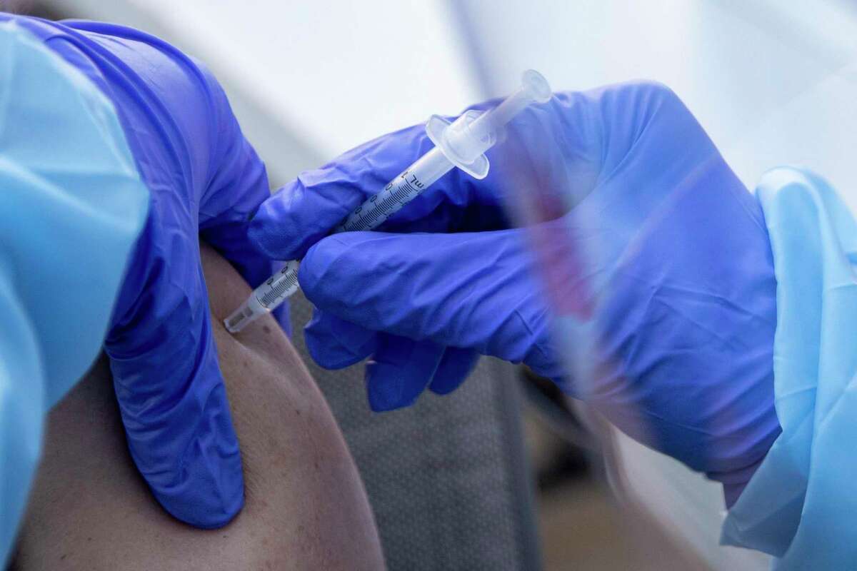 A Marin County nurse administers a coronavirus vaccination vaccine. The county’s health officer Dr. Mattis Willis says COVID-19 case rates now surpass those during the delta surge of summer 2021, making the current swell of infections “a fifth surge in our pandemic course.”
