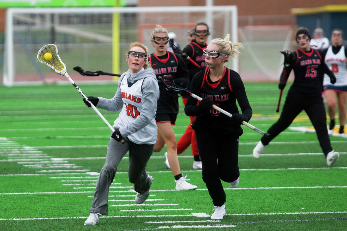Midland's Emma Murphy carries the ball during a game against Grand Blanc Tuesday, April 26, 2022 at Midland Community Stadium.
