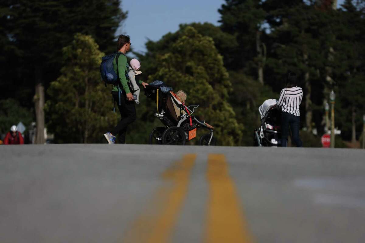Folks exercise on JFK Drive in Golden Gate Park on Tuesday. The Board of Supervisors voted Tuesday to keep 1.5 miles of JFK Drive permanently closed to cars.