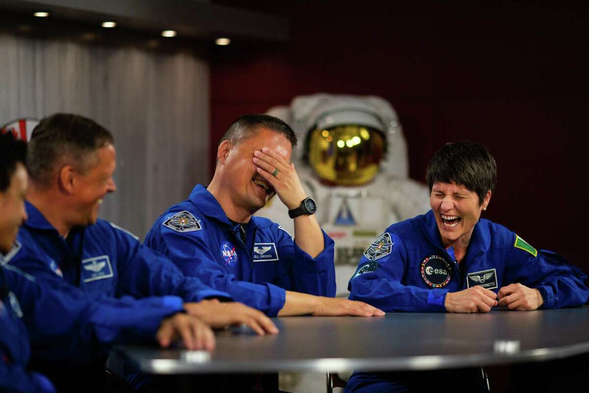 NASA astronaut and SpaceX Crew-4 commander Kjell Lindgren and European Space Agency astronaut and Crew-4 mission specialist Samantha Cristoforetti of Italy share a laugh minutes before starting a Q&A session virtually at the NASA Johnson Space Center, Thursday, March 31, 2022, in Houston.