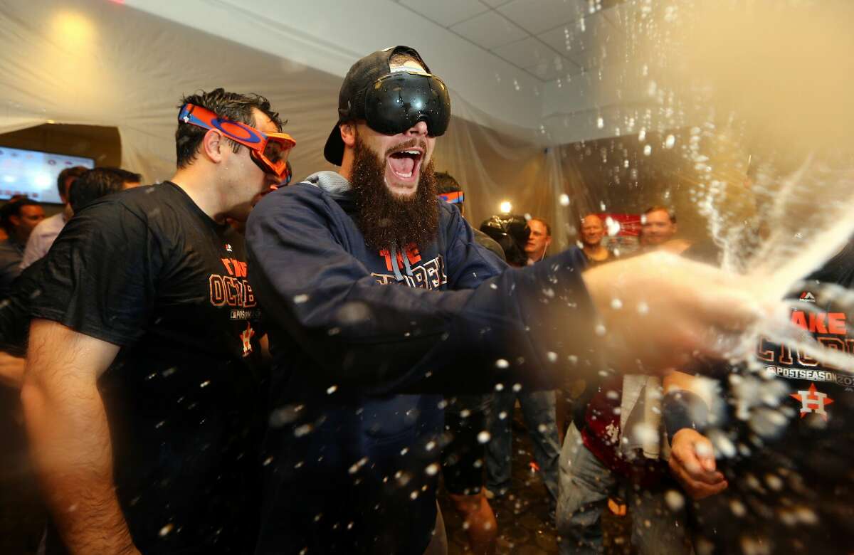 Dallas Keuchel of the Houston Astros celebrate with his teammates in the locker room after defeating the New York Yankees in the American League Wild Card Game at Yankee Stadium on October 6, 2015 in New York City. The Astros defeated the Yankees 3-0.