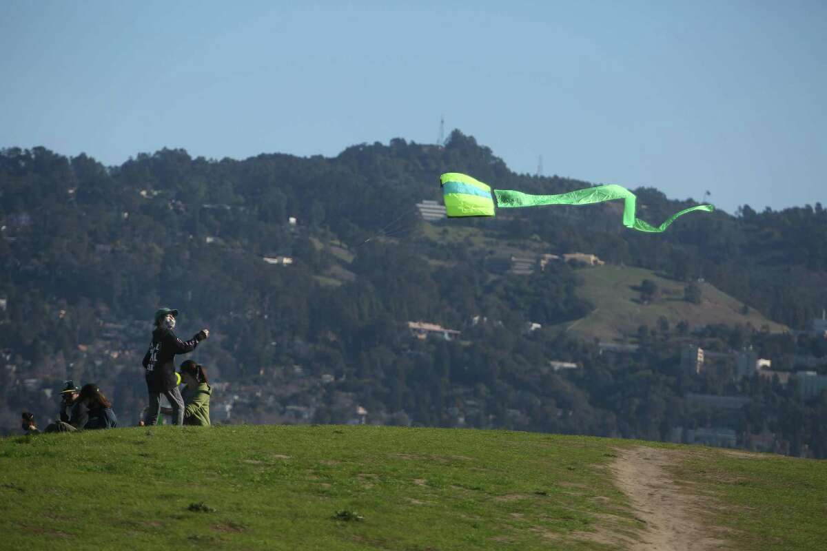 Miles Sobky, 12, flies his kite at César E. Chávez Park as he spends time at the park with his mother Heather Sobky, right, on Monday, January 18, 2021 in Berkeley, Calif. Winds with gusts between 45 and 60 mph will whip through parts of the Bay Area starting Wednesday evening, meteorologists said.