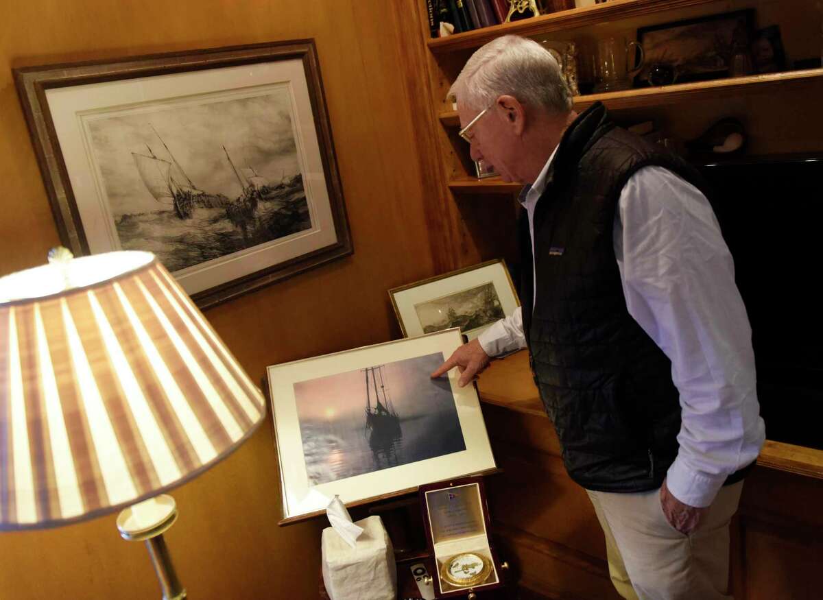 David Tunick shows a photo of his boat at his home in Stamford, Conn., Monday, Feb. 21, 2022. The 78-year-old plans to embark on a journey of approximately 5,000 nautical miles from the Spain to Connecticut on his personal sailboat this May.