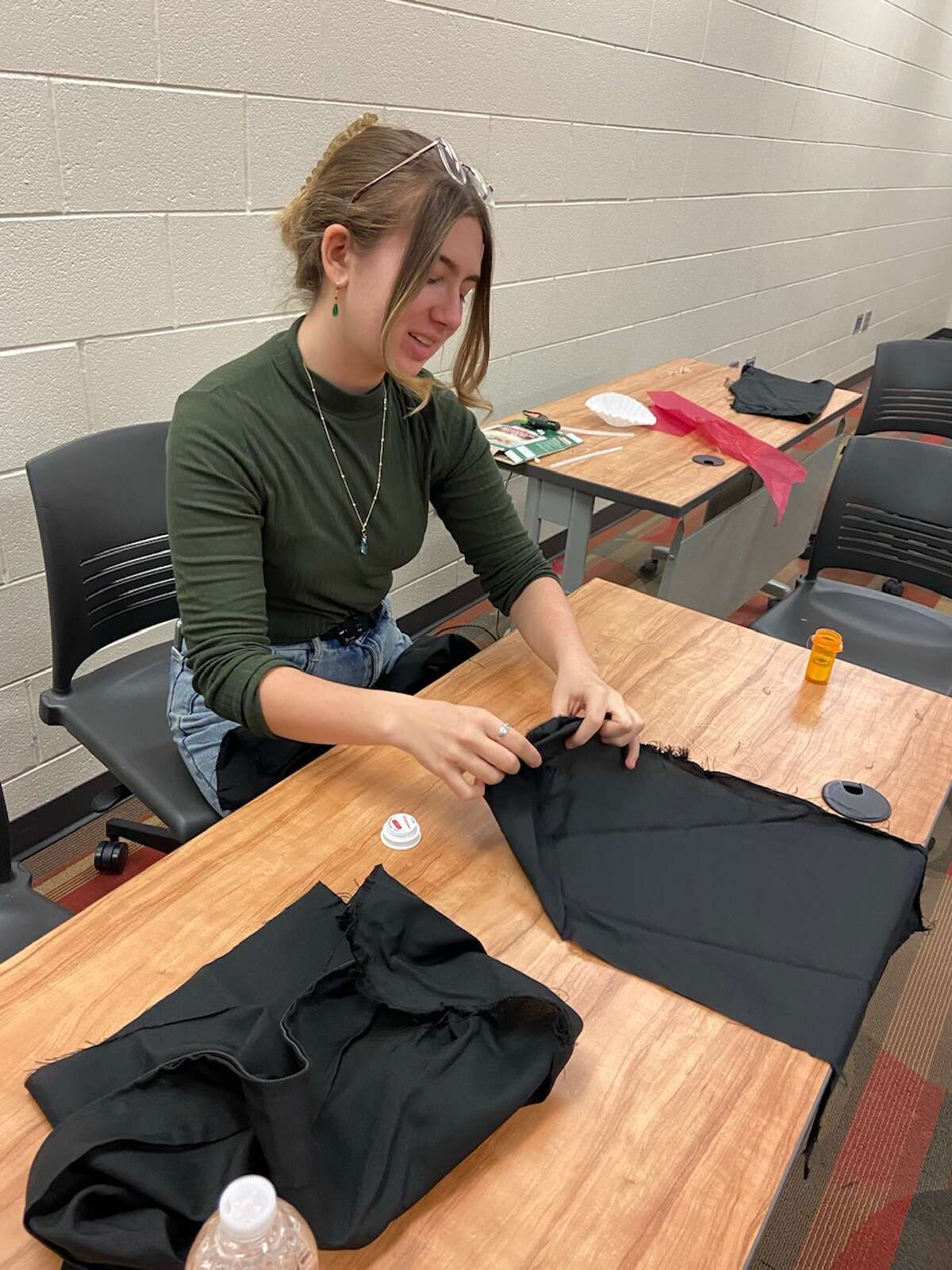 Big Rapids students Corbin Richeson, Paisley Prosser, and Abbie Strasser participated and made a fashion statement by turning different textiles and trash items into a wearable gown.