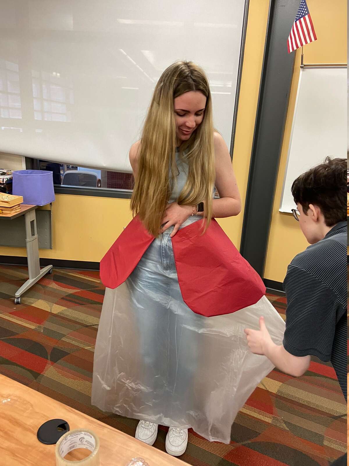 Big Rapids students Corbin Richeson, Paisley Prosser, and Abbie Strasser participated and made a fashion statement by turning different textiles and trash items into a wearable gown.