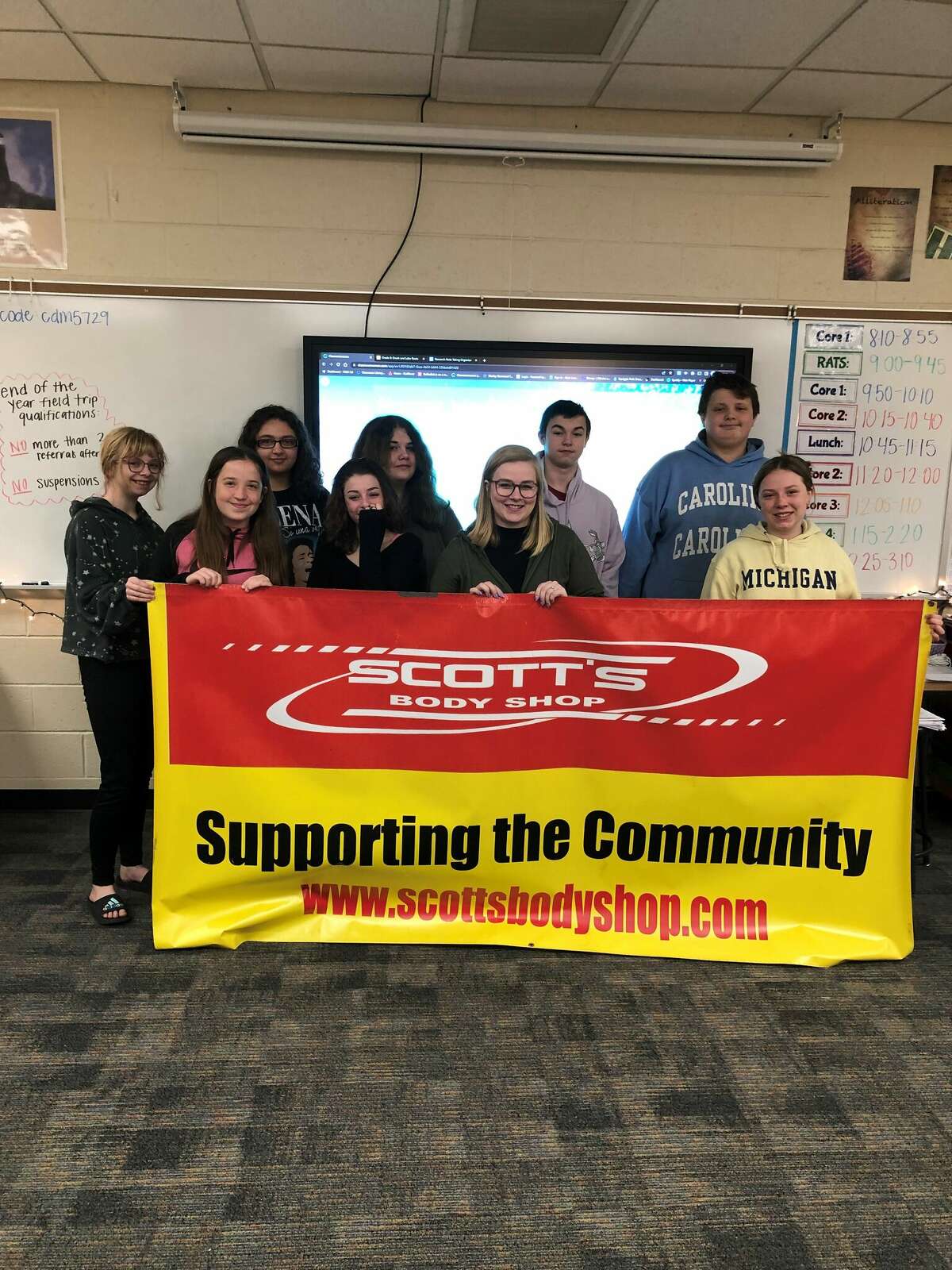 Teacher Hailey Coty and her eighth-grade English class pose for a photo after she was nominated as Morley Stanwood Community School's Teacher of the Month for February.  