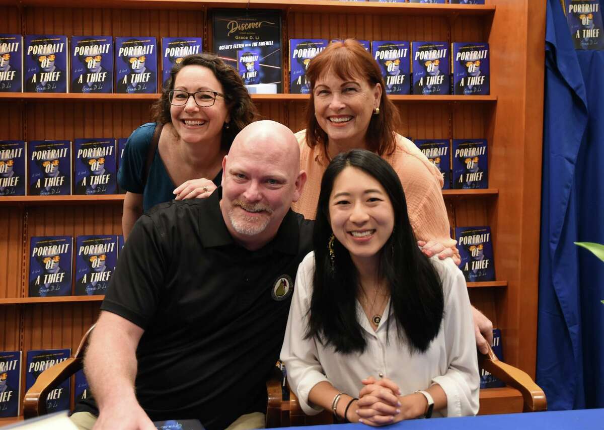 Dawson High School teachers Diana Gano, left, and George McKendree and Pearland Independent School District Director of Advanced Academics Margo Gigee join their former student Grace Li at a recent event promoting Li's book “Portrait of a Thief.”