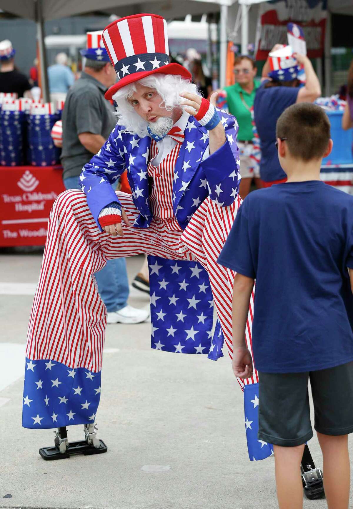 Uncle Sam Ryan Magnuson motions to Jack Wingo, 10, to come visit before the Houston Symphony Star-Spangled Salute honoring the 50th anniversary of the moon landing, NASA’s Bill Davidson, and the armed forces at the Cynthia Wood Mitchell Pavilion Wednesday, July 3, 2019, in The Woodlands.
