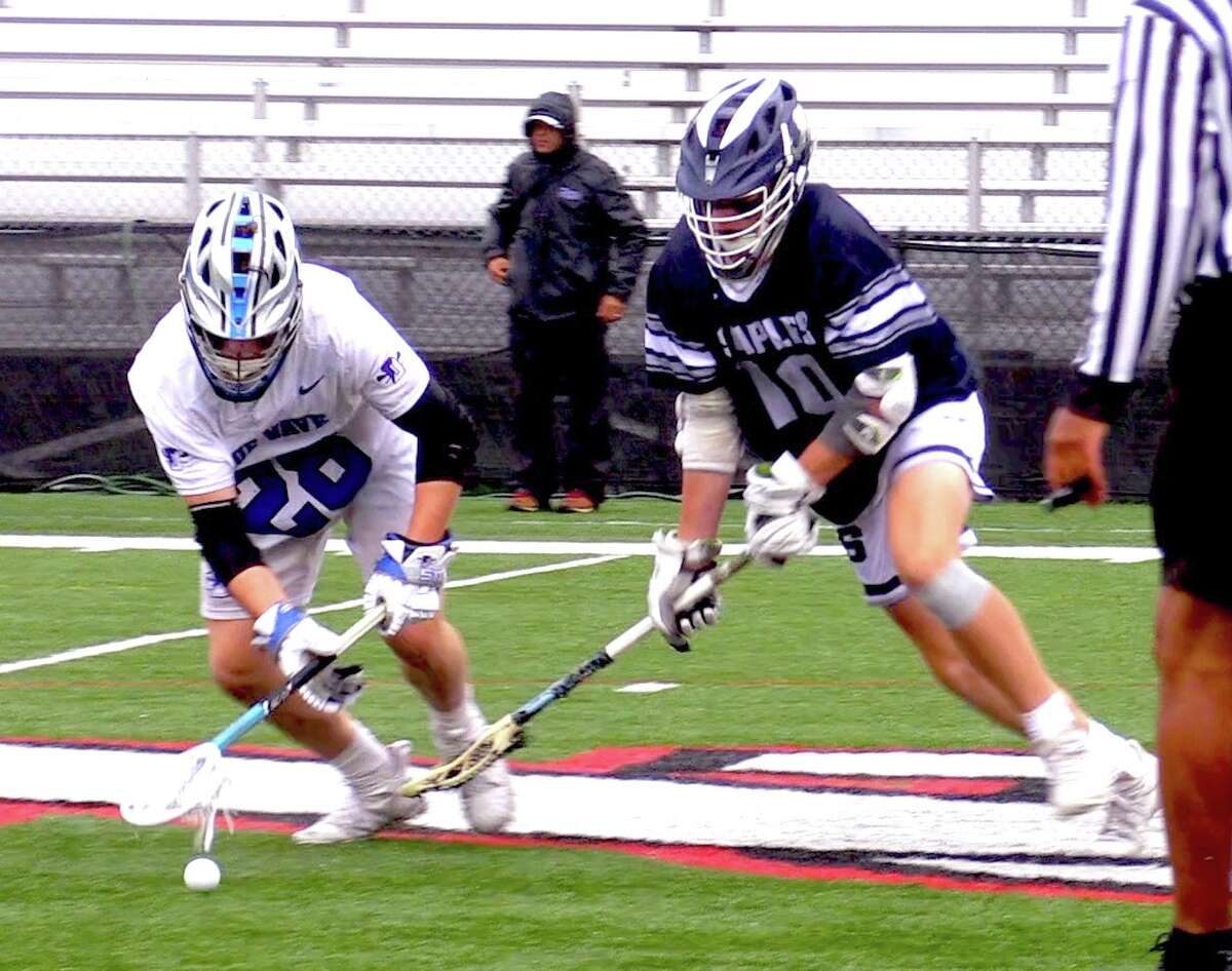 Darien's Tighe Cummiskey (left) and Staples' Henry Dodge (10) battle for a faceoff in the 2021 FCIAC Boys Lacrosse Championship game. Darien won the game 15-3. The teams, now ranked No. 1 and No. 2 in the GameTimeCT Top 10 Poll, will face off for the first time since then at Darien on Thursday, April 28, 2022.