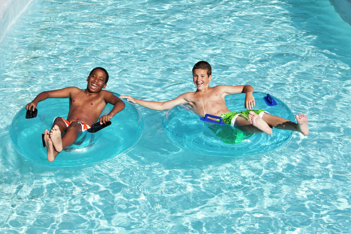Two boys floating down lazy river.