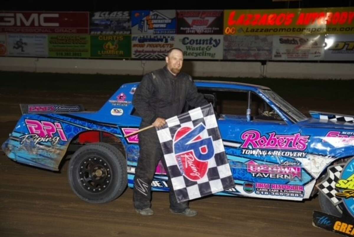 Mike Arnold poses with his street stock car.