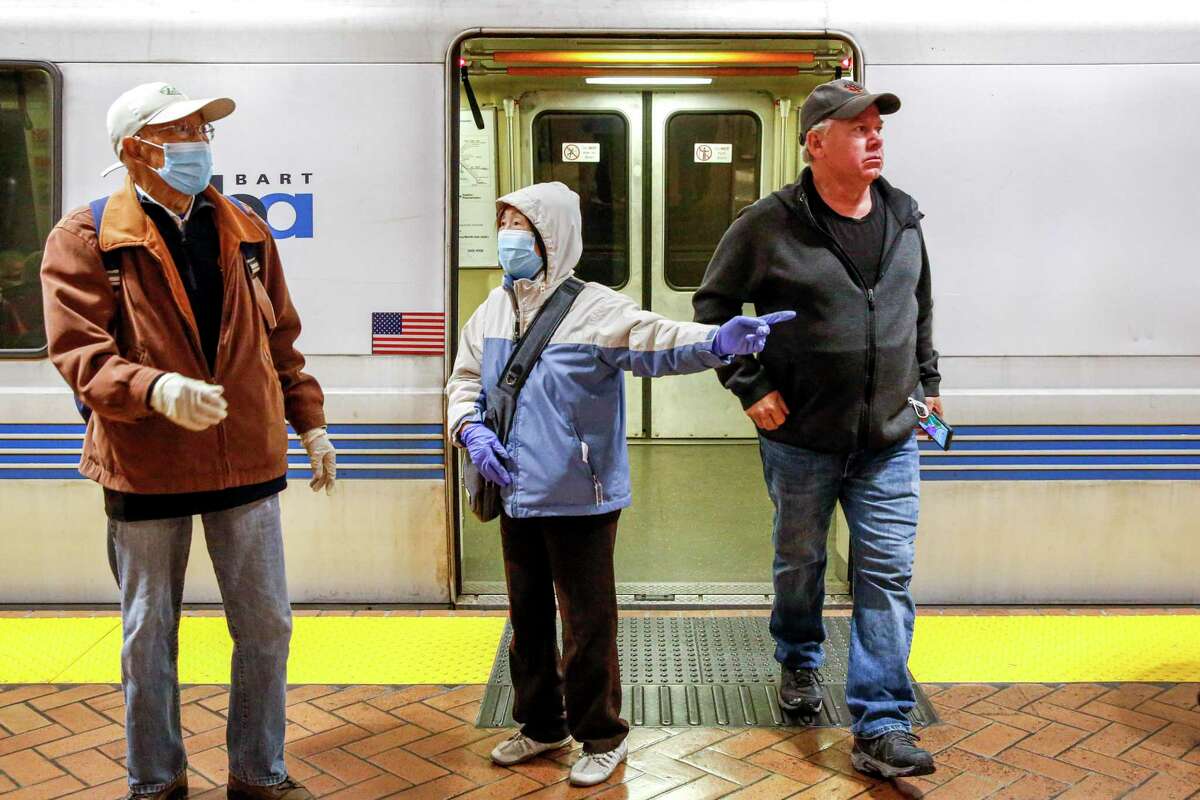 Some BART passengers wear masks on April 19 after the transportation agency said it would stop enforcing masking after a U.S. district judge struck down the federal mandate for public transit.
