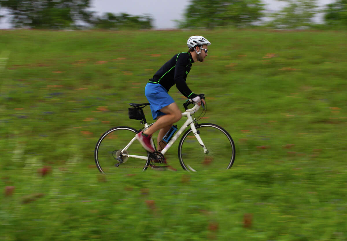 A bicyclist riding on a trail.