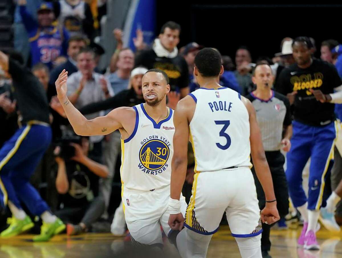 Golden State Warriors guard Stephen Curry (30) is congratulated by guard Jordan Poole (3) after scoring against the Denver Nuggets during the first half of Game 2 of an NBA basketball first-round playoff series in San Francisco, Monday, April 18, 2022. (AP Photo/Jeff Chiu)