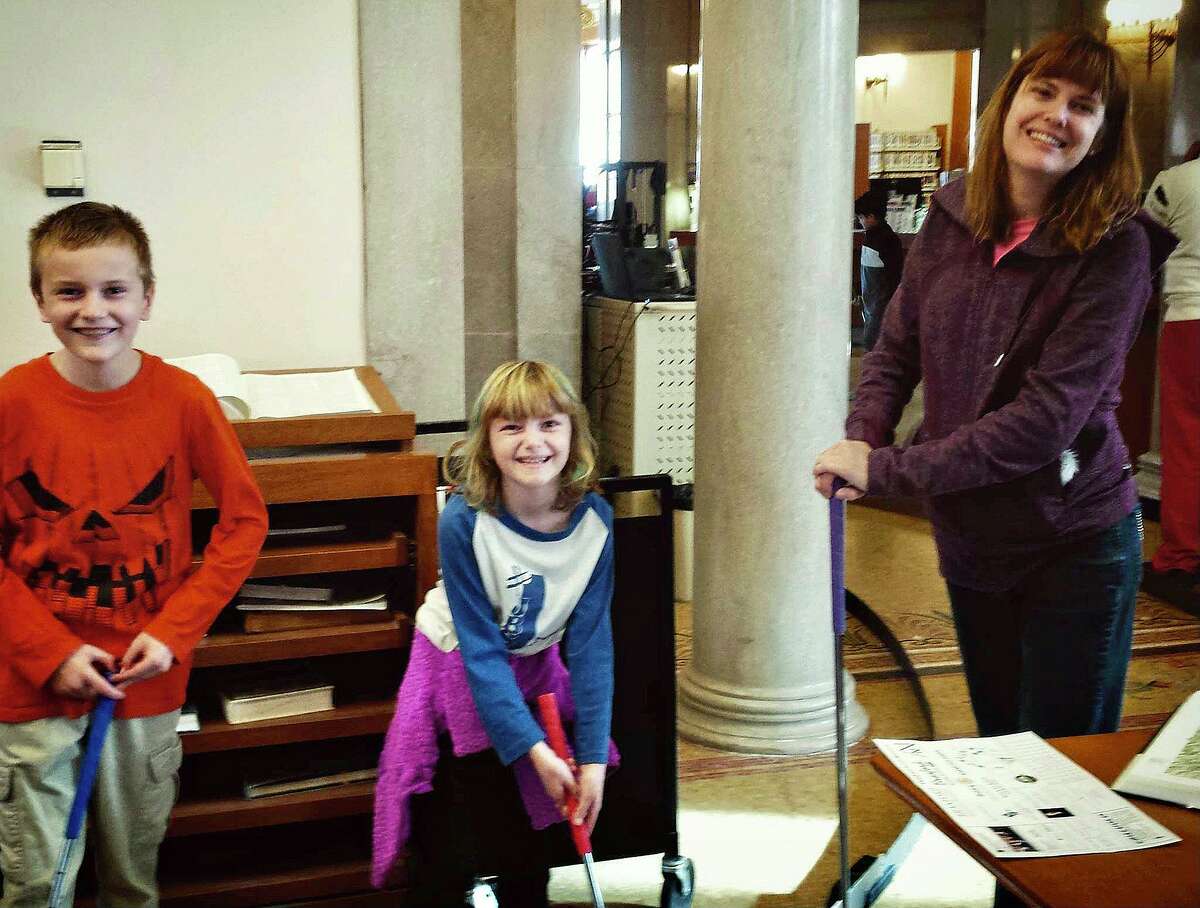 Playing to the gallery at the 2016 mini golf event at Blackstone Memorial Library