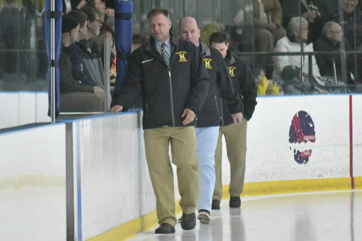 Hamden coach Todd Hall walks onto the ice prior to the start of the game against Notre Dame-West Haven in 2018.