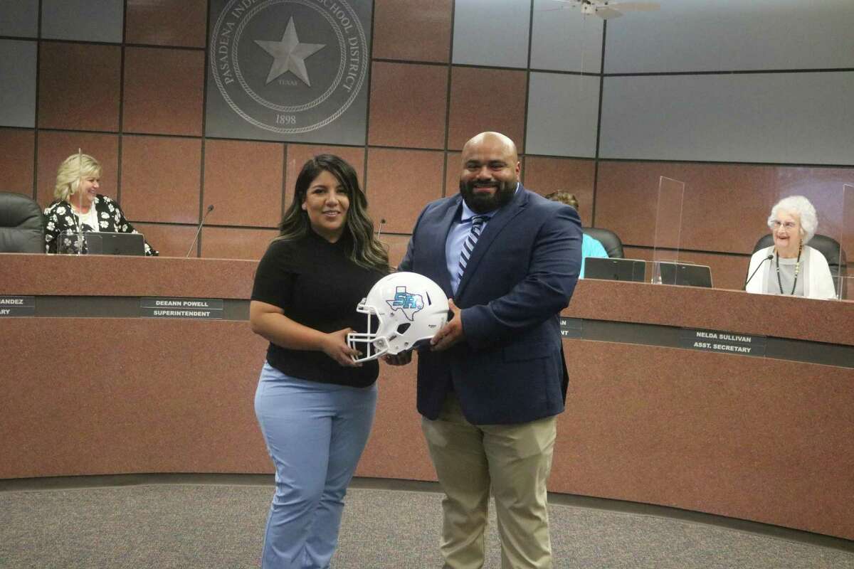 Sergio Gonzalez is joined by his wife Analia at the Pasadena ISD school board meeting Tuesday night following the announcement that he has been named Sam Rayburn's new head football coach.