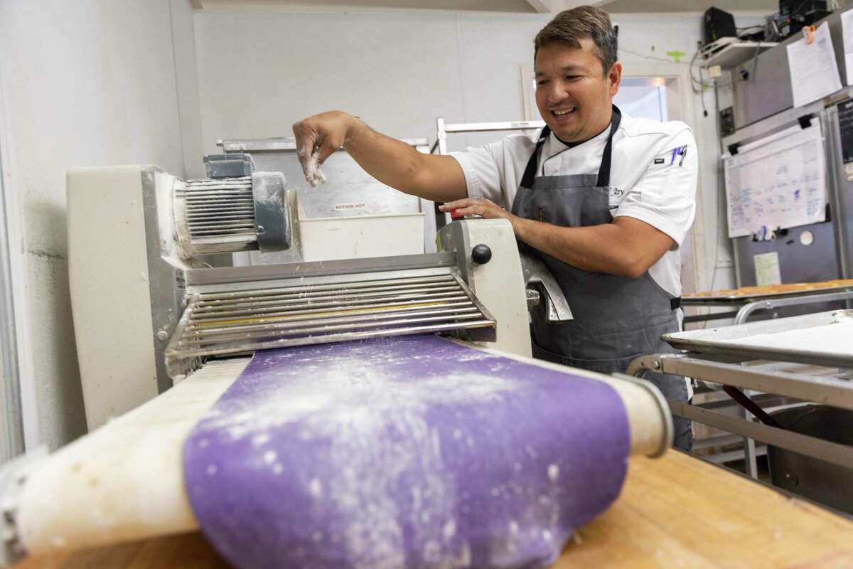 Jay Magsano stretches dough for ube croissants at Le Paris Artisan & Gourmet Cafe in American Canyon.