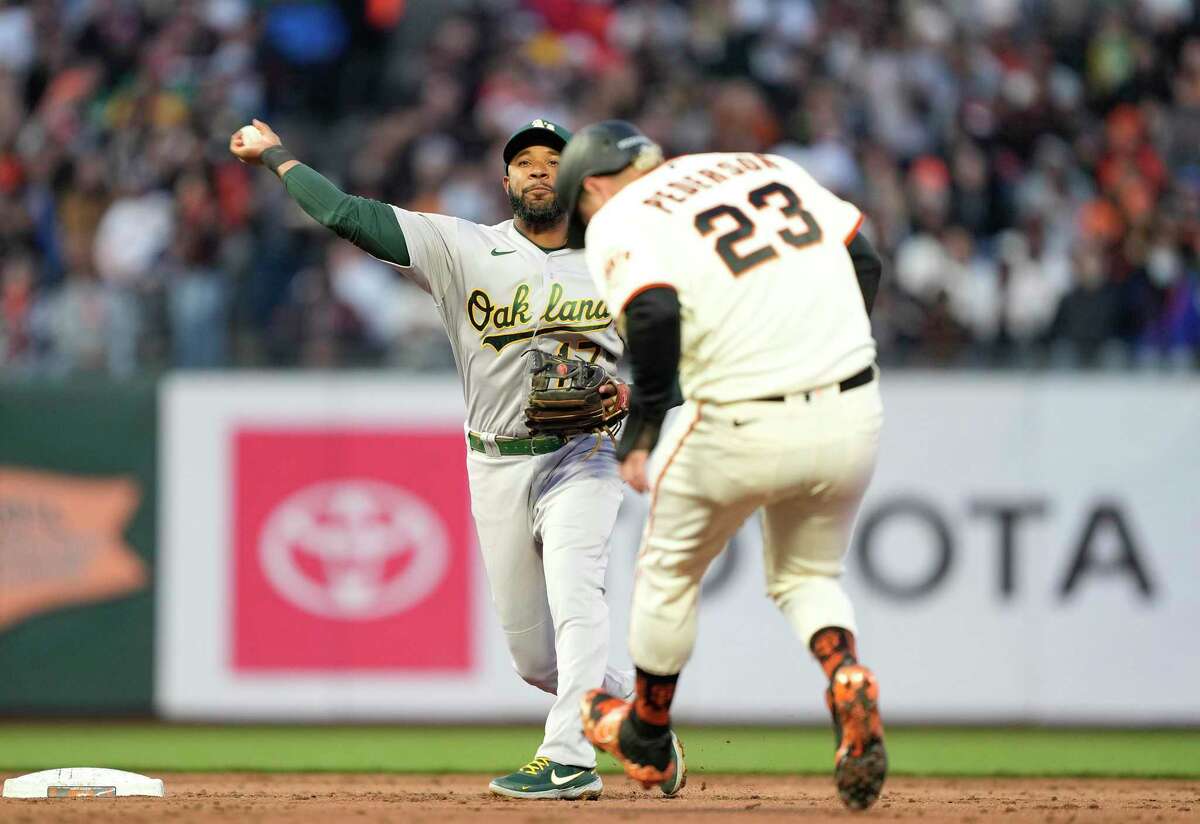 Giants' Joc Pederson leaves with groin tightness in loss to A's. SAN FRANCISCO, CALIFORNIA - APRIL 27: Elvis Andrus #17 of the Oakland Athletics completes the double-play by throwing over the top of Joc Pederson #23 of the San Francisco Giants in the bottom of the third inning at Oracle Park on April 27, 2022 in San Francisco, California. (Photo by Thearon W. Henderson/Getty Images)
