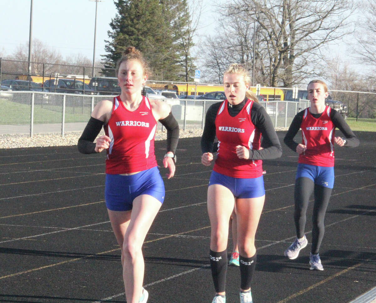 Chippewa Hills Sarah Storey (left) leads the way for her Warrior teammates during Wednesday's CSAA meet
