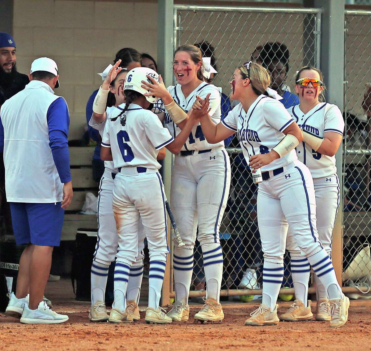 MacArthur Ariana Gonzales (6) is surrounded by teammates after scoring in a HS Softball Playoffs where MacArthur defeated Clemens 11-1 on Wednesday, April 27, 2022 at Blossom Athletic Field.
