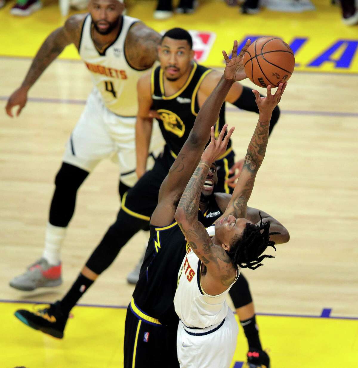 Draymond Green (23) defends against Bones Hylund (3) In the second half as the Golden State Warriors played the Denver Nuggets in Game 5 of the first round of the NBA Playoffs at Chase Center in San Francisco, Calif., on Wednesday, April 27, 2022.