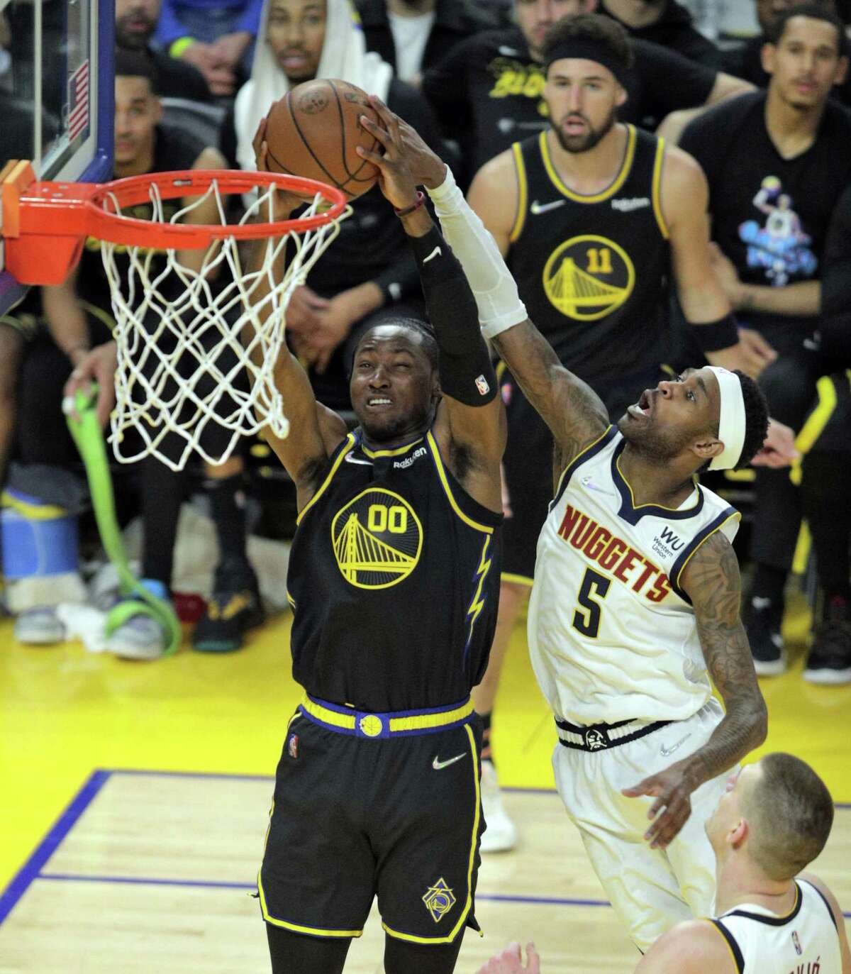 Jonathan Kuminga (00) dunks defended by Monte Morris (Will BArton (5) In the first half as the Golden State Warriors played the Denver Nuggets in Game 5 of the first round of the NBA Playoffs at Chase Center in San Francisco, Calif., on Wednesday, April 27, 2022.