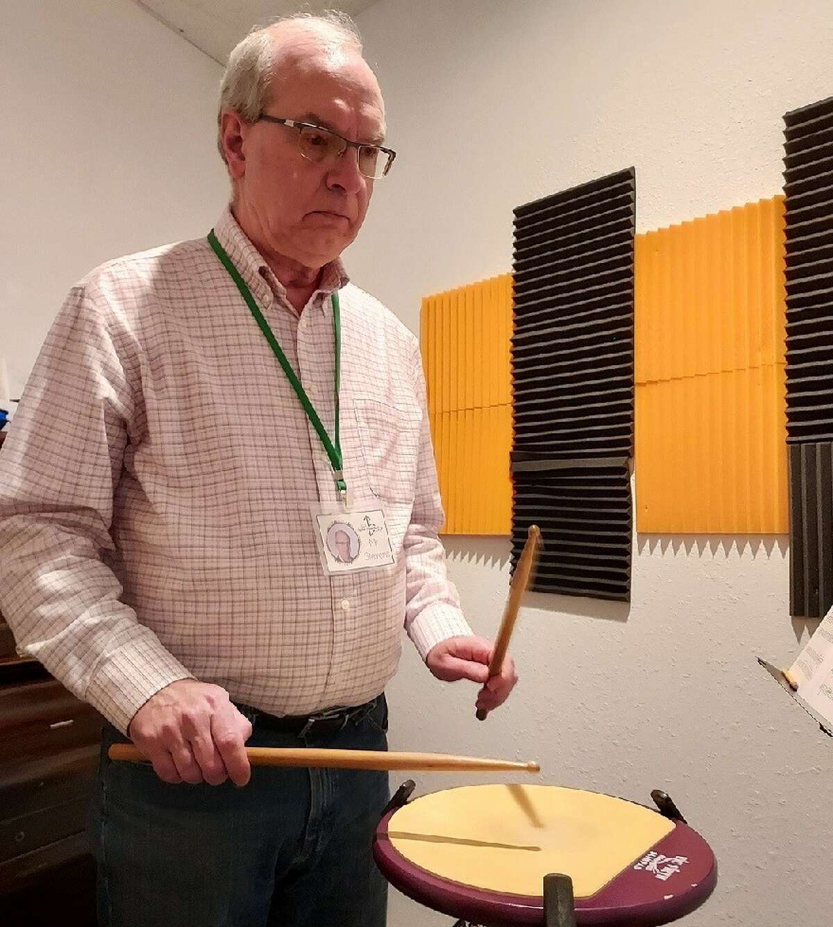 Longtime music teacher Roger Stevens of Midland keeps an eye on a young drummer from Auburn (not pictured) as they practice for a duet during a recent music lesson at UpBeat Music Academy.