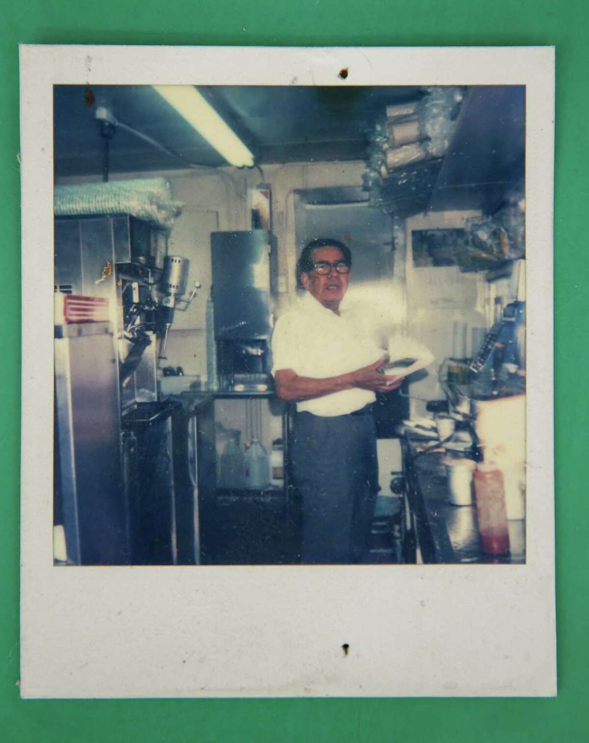 A picture of Carlos P. Martinez, Poppa Burger’s second owner, working inside the kitchen. Photographed on Tuesday, April 12, 2022, in Houston.