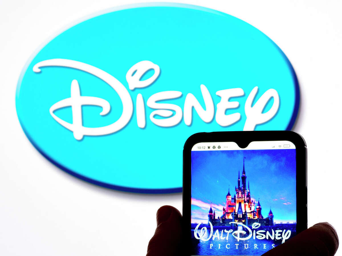 UKRAINE - 2022/01/19: In this photo illustration, the Walt Disney Pictures logo is seen displayed on a smartphone screen with the Disney logo in the background. (Photo Illustration by Igor Golovniov/SOPA Images/LightRocket via Getty Images)