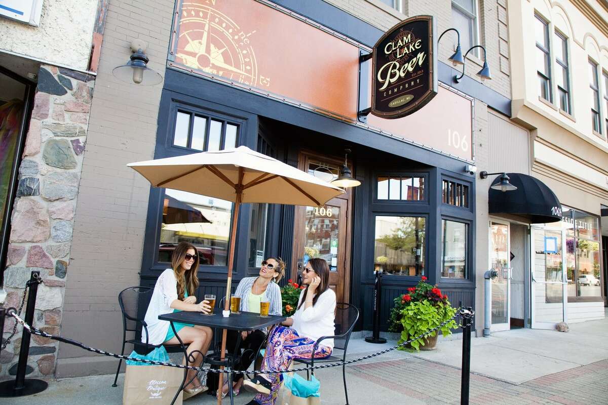 Three customers enjoy a cold one at Clam Lake Beer Company in downtown Cadillac's new social district. Known as the Commons District, the initiative is energizing the community's business district.