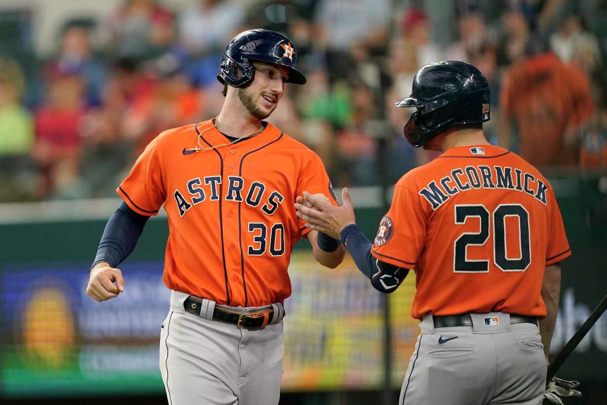 Houston Astros' Kyle Tucker (30) celebrates with Chas McCormick (20) after hitting a two-run home run in the eighth inning of a baseball game against the Texas Rangers, Thursday, April 28, 2022, in Arlington, Texas. Tucker was pinch-hitting in the plate appearance that scored Jeremy Pena. (AP Photo/Tony Gutierrez)
