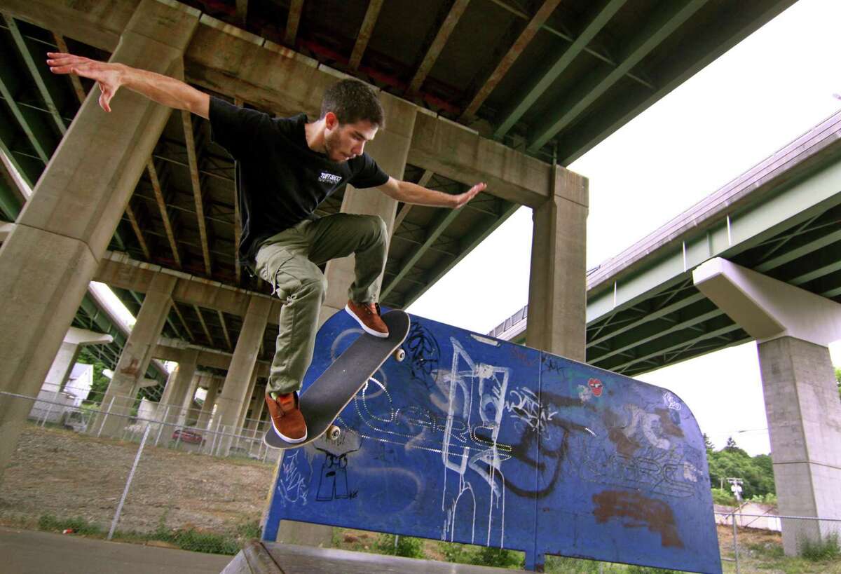 A man practices tricks on his skateboard at the skate park underneath Route 8 in Shelton, Conn. in 2016.