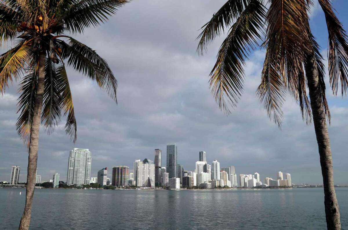 This Feb. 2, 2018, file photo shows the skyline of Miami, where the woman who faced charges after a viral video showed her coughing on and allegedly assaulting an Uber driver in San Francisco last year has been arrested in an unrelated case of identity theft, authorities said.