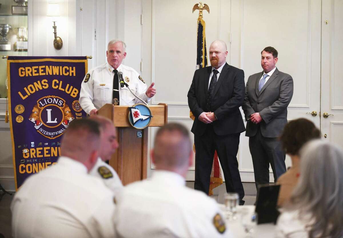 Greenwich Police Chief James Heavey, left, presents Detectives Jeremiah Bussell, center, and Gregory Parillo with their awards at the Greenwich Police Department's annual John Clarke Award presentation at Riverside Yacht Club in the Riverside section of Greenwich, Conn. Thursday, April 28, 2022. The ceremony had not be held for the last three years due to COVID, so the 2019 award was presented to Detectives Gregory Parillo and Jeremiah Bussell, the 2020 award was presented to all officers and staff of the Greenwich Police Department, and the 2021 award was presented to Detective First Grade Christy Girard.