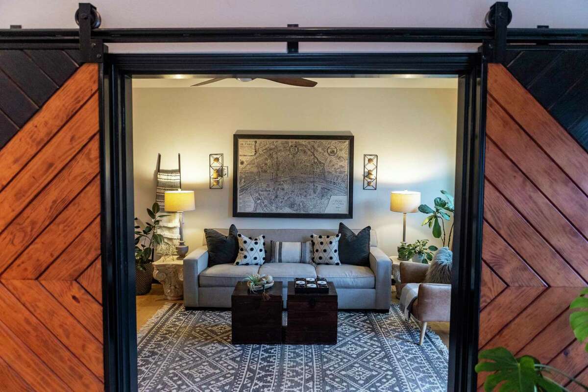 The barn doors lead to a smaller room the couple uses as a comfortable second living area.