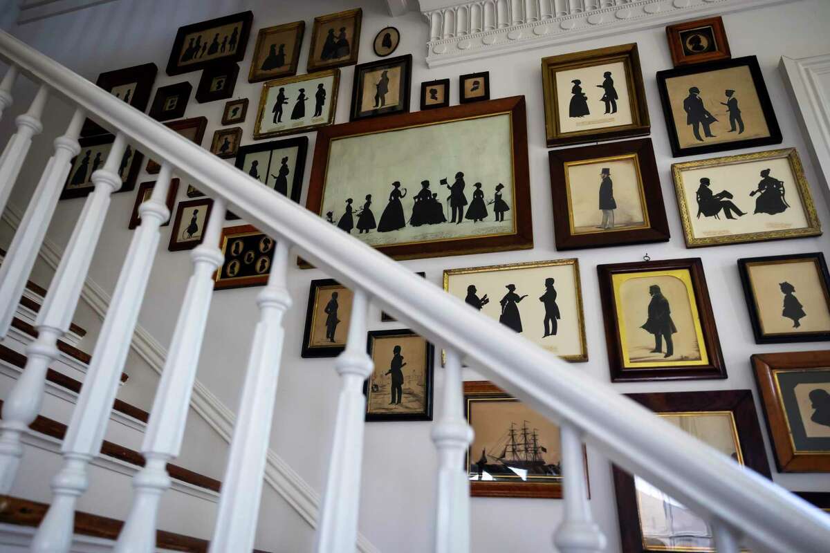 Antique silhouettes line the stairway in the historic home owned and restored by design mother/daughter duo Mary Louise Stonecypher and Jordan Vaughn in Galveston on Saturday, April 22, 2022.