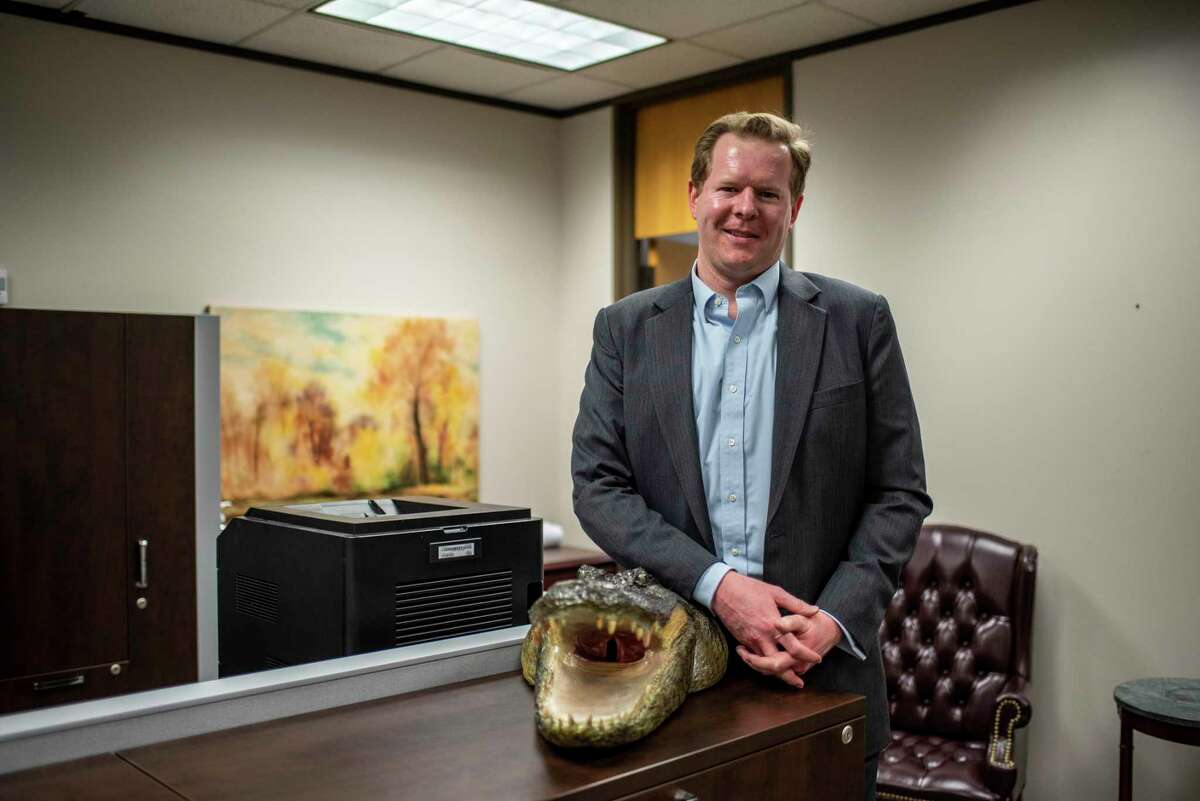 Public Utility Commission Chairman Peter Lake poses next to an alligator in his office on Thursday, Sept. 2, 2021 in Austin, TX. Lake spoke about the state of the energy situation in Texas and how they are looking for ways to give Texans energy without interruptions or losses. (Sergio Flores/Houston Chronicle)